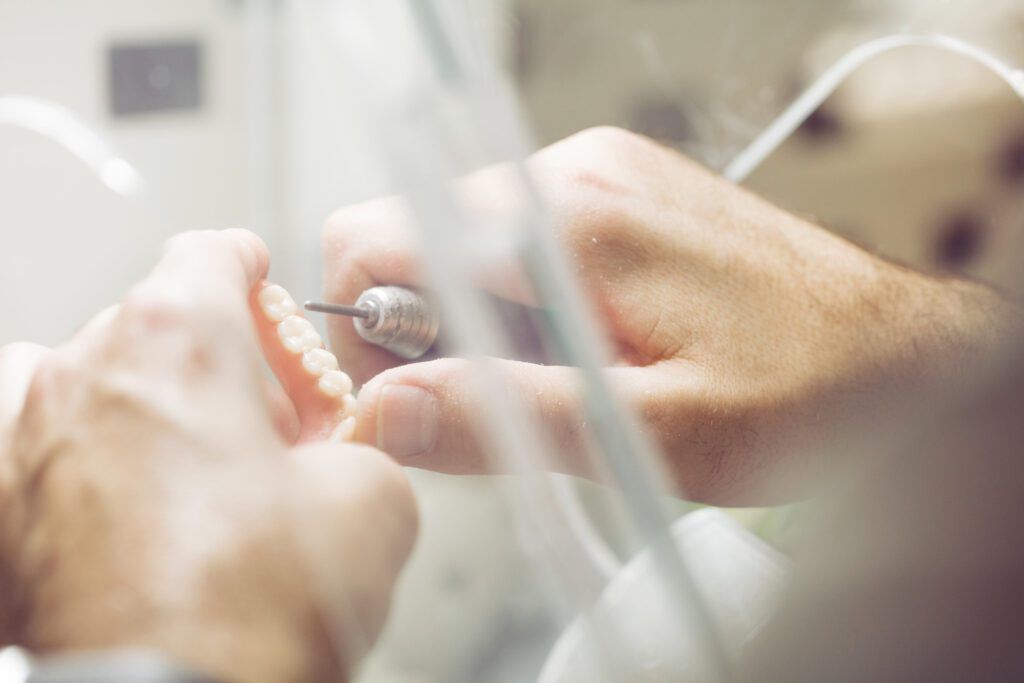 Dentist crafting a set of dentures in The Woodlands