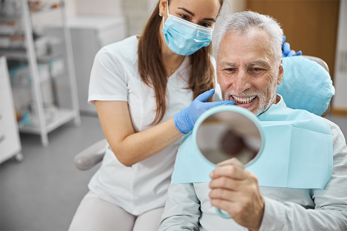 A dentist showing a patient his new smile