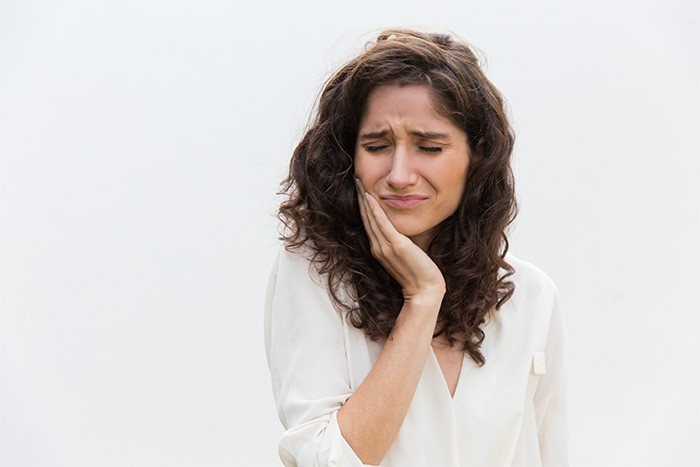 Grimacing woman with a toothache