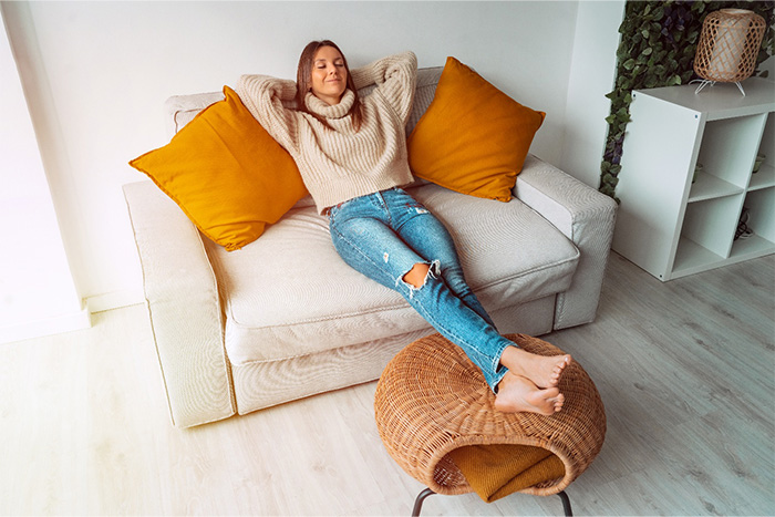 Woman relaxing in comfy chair at home