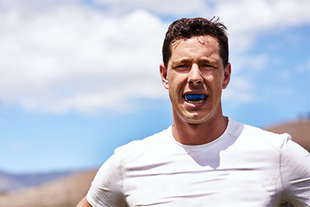Always wear a mouthguard if you play sports to protect your teeth and dental implants