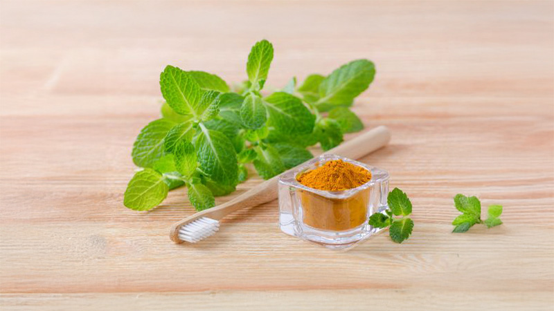 A toothbrush and turmeric powder.