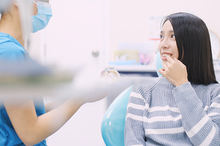 The Woodlands patient talking to dentist about teeth whitening.