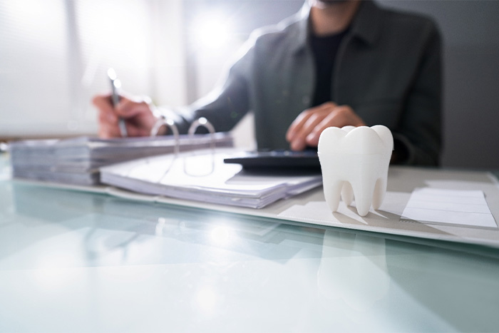Patient in The Woodlands calculating root canal costs.