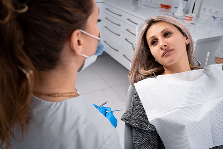 The Woodlands patient comparing root canal vs extraction.