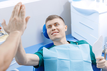Patient high-fiving dentist.